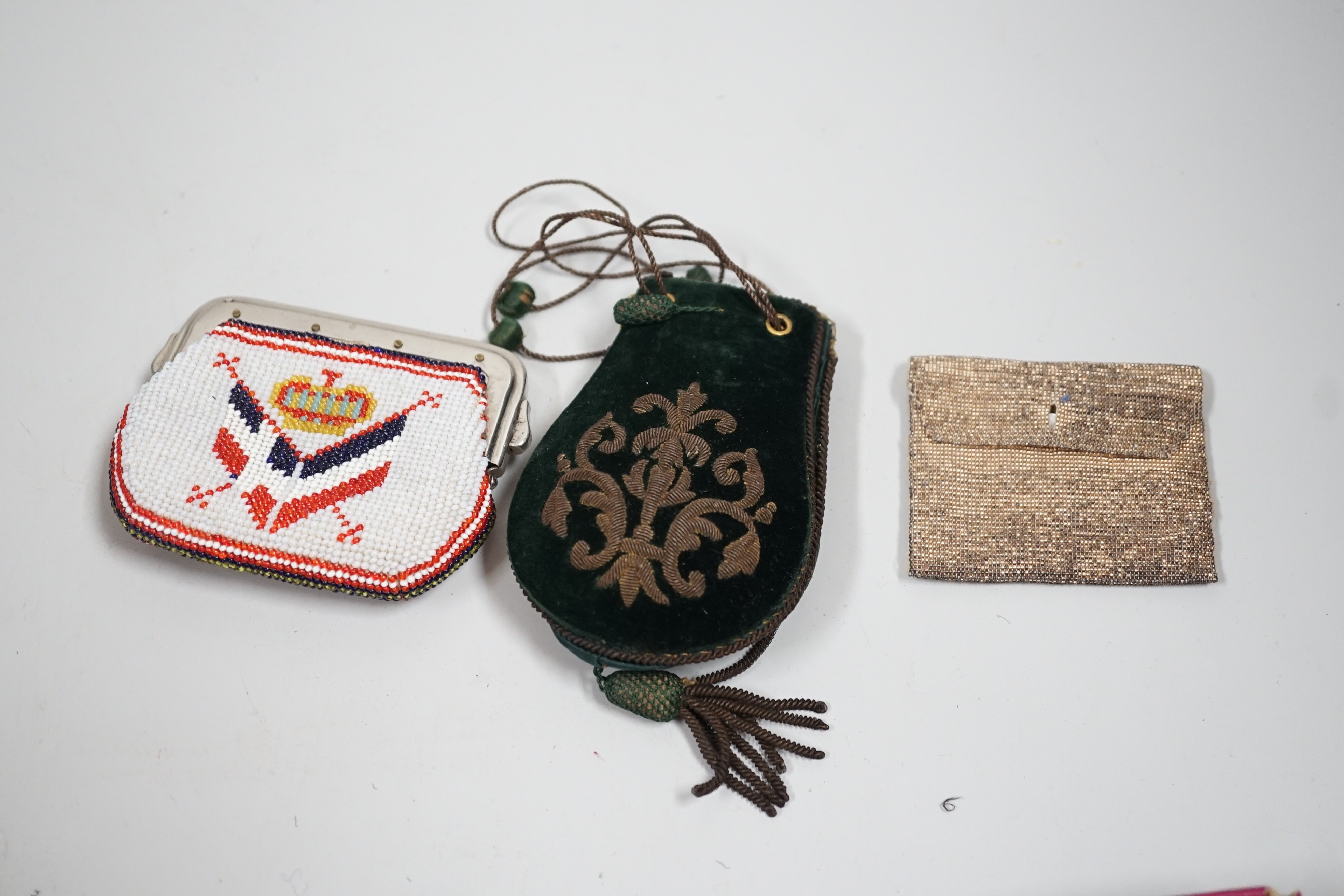 A velvet and metal embroidered reticule possibly 18th century, together with a collection of beaded embroidered knitted and leather purses, bags misers purses and a feather coin purse(14)